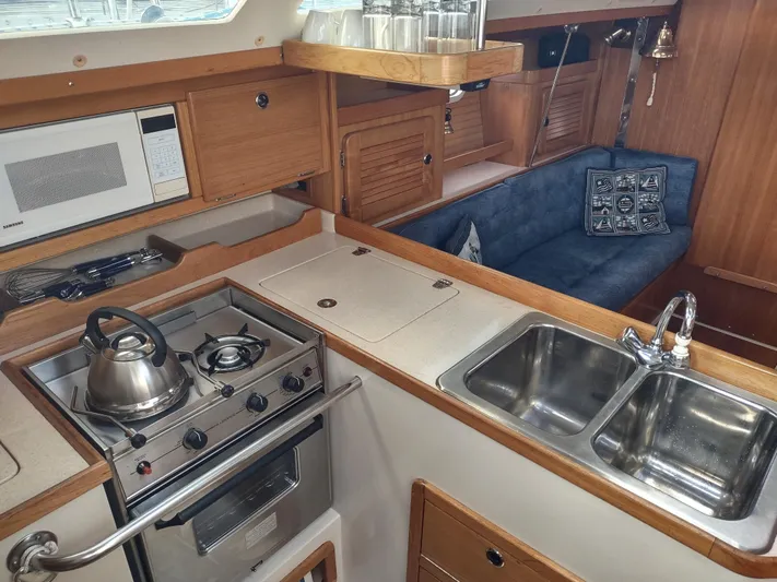 Bluebird Yacht Photos Pics Interior of 2002 Catalina 36 MkII yacht with kitchen and seating area.