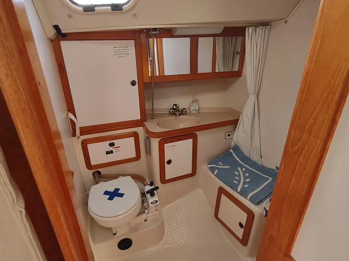 Bluebird Yacht Photos Pics Interior of 2002 Catalina 36 MkII yacht bathroom with sink, toilet, and storage.