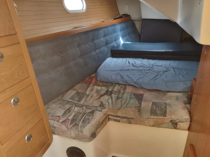 Bluebird Yacht Photos Pics Cozy cabin interior of 2002 Catalina 36 MkII sailboat with cushioned seating and wooden cabinetry.