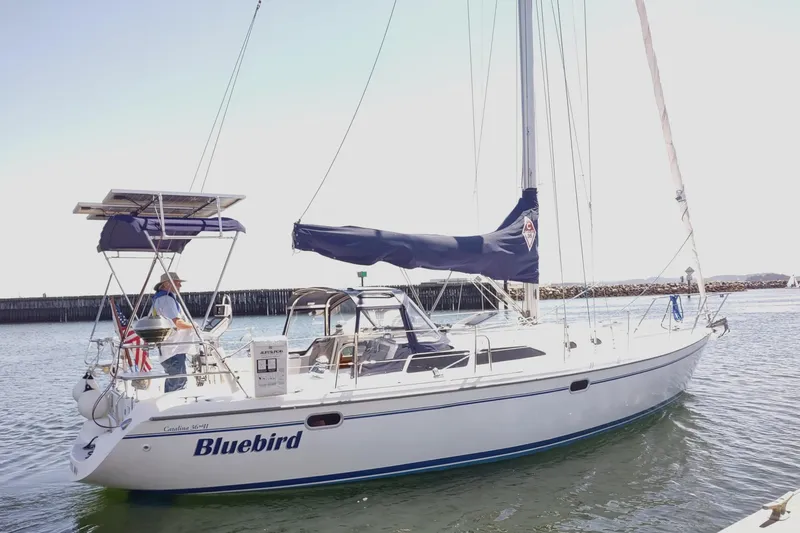 Bluebird Yacht Photos Pics 2002 Catalina 36 MkII sailboat "Bluebird" on water with solar panels and American flag.