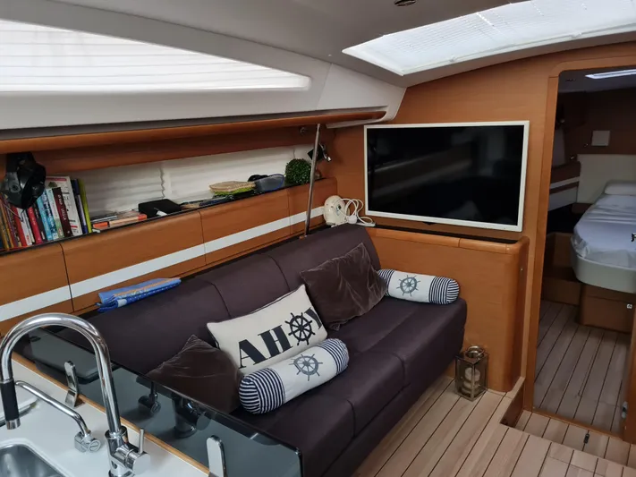  Yacht Photos Pics Luxurious interior of a 2015 Jeanneau 57 yacht with modern amenities and cozy seating.