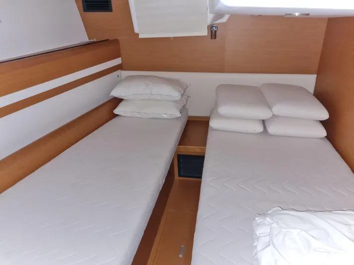  Yacht Photos Pics Cabin interior of 2015 Jeanneau 57 yacht with twin beds and pillows.