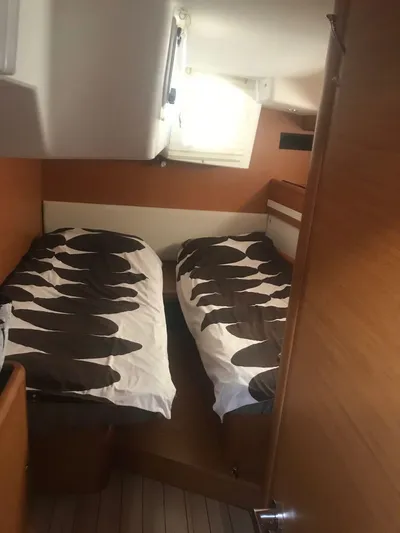  Yacht Photos Pics Interior cabin of 2015 Jeanneau 57 yacht with twin beds and wooden finish.