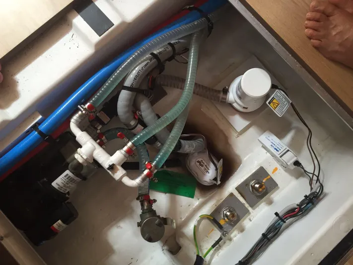  Yacht Photos Pics Engine compartment of a 2015 Jeanneau 57 yacht, showing hoses and electrical components.