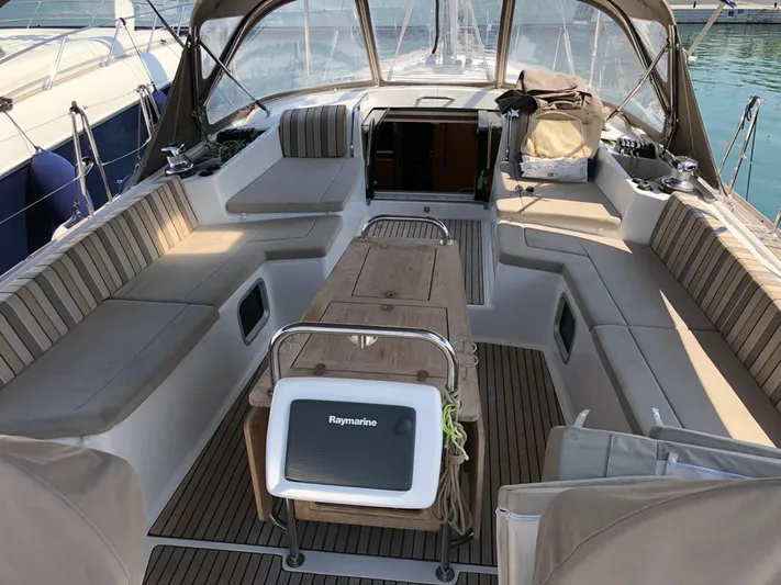  Yacht Photos Pics Spacious cockpit of a 2015 Jeanneau 57 sailboat with seating and navigation equipment.