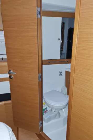  Yacht Photos Pics 2015 Jeanneau 57 yacht bathroom with wooden door and modern fixtures.