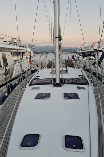  Yacht Photos Pics Jeanneau 57 sailboat, 2015 model, docked at marina during sunset.