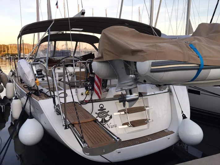  Yacht Photos Pics 2015 Jeanneau 57 yacht docked with covered dinghy and elegant deck design.