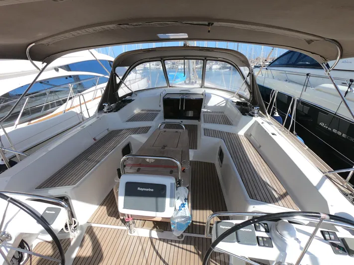 Yacht Photos Pics 2015 Jeanneau 57 yacht cockpit with dual steering wheels and spacious seating area.
