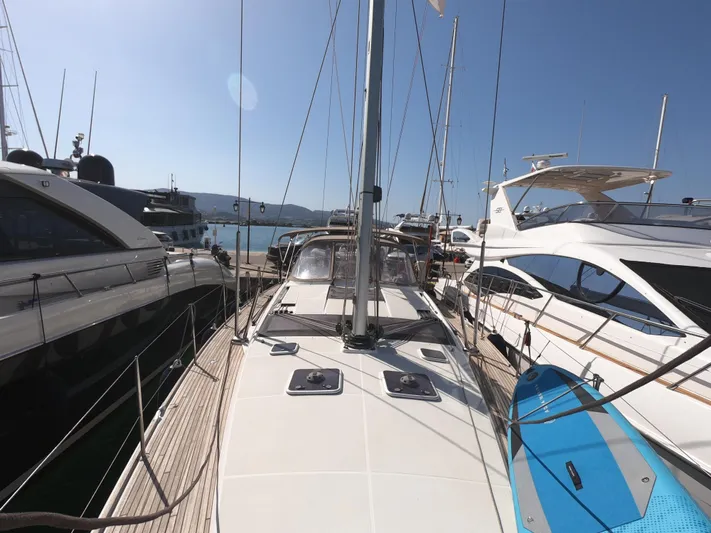  Yacht Photos Pics 2015 Jeanneau 57 yacht docked among other boats under clear blue sky.