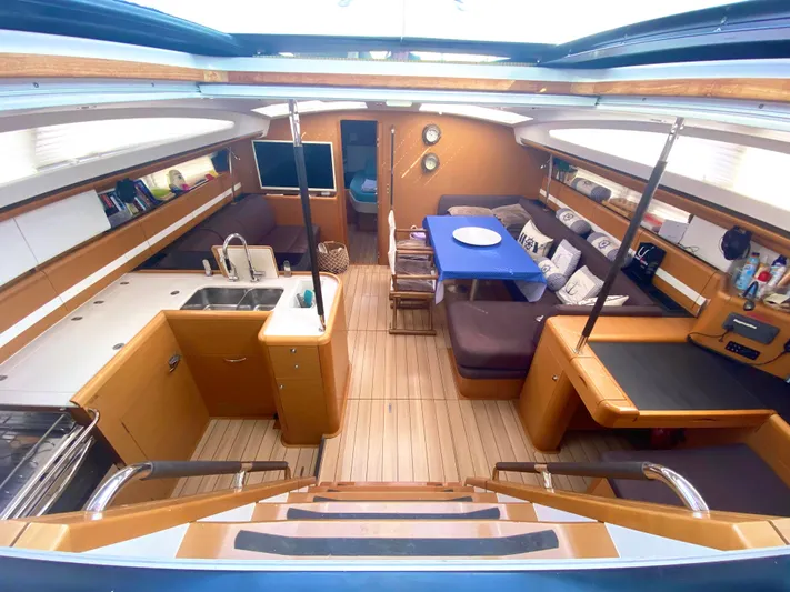  Yacht Photos Pics Luxurious interior of a 2015 Jeanneau 57 yacht with modern kitchen and seating area.