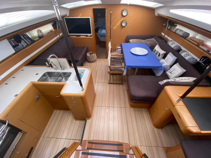  Yacht Photos Pics Luxurious interior of a 2015 Jeanneau 57 yacht with modern kitchen and cozy seating area.