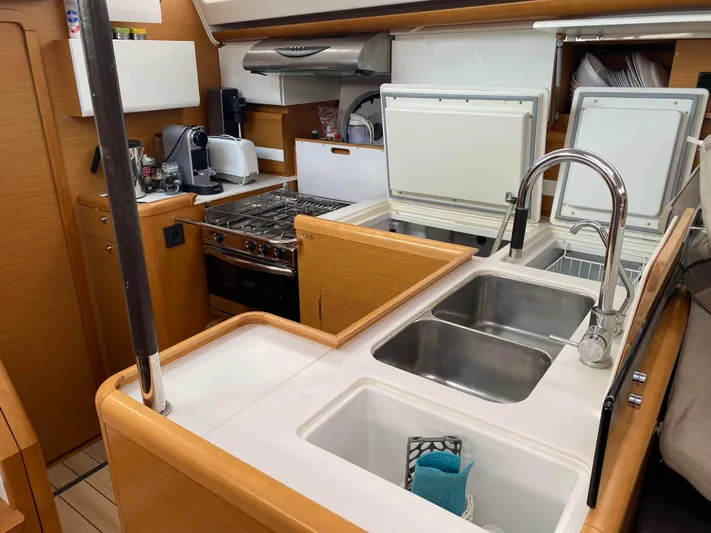  Yacht Photos Pics Modern kitchen in a 2015 Jeanneau 57 yacht with dual sinks and appliances.