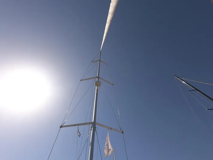  Yacht Photos Pics Sailboat mast of 2015 Jeanneau 57 against clear blue sky and bright sun.