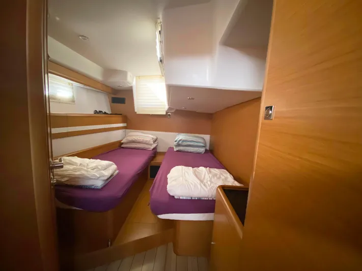  Yacht Photos Pics Cabin interior of 2015 Jeanneau 57 yacht with twin beds and wooden finish.