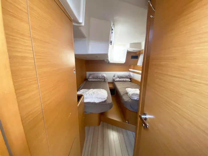  Yacht Photos Pics Cabin interior of 2015 Jeanneau 57 yacht with twin beds and wooden finish.
