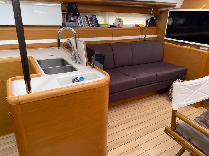  Yacht Photos Pics Luxurious interior of a 2015 Jeanneau 57 yacht with modern kitchen and cozy seating area.