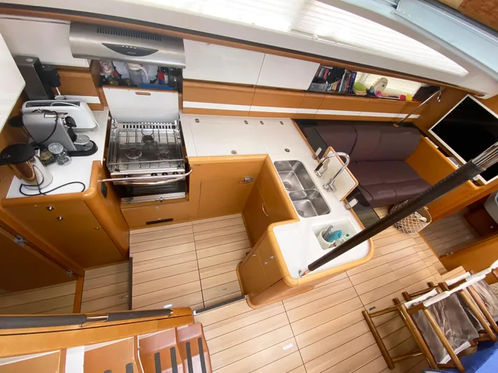  Yacht Photos Pics Luxurious interior of a 2015 Jeanneau 57 yacht featuring a modern kitchen and seating area.