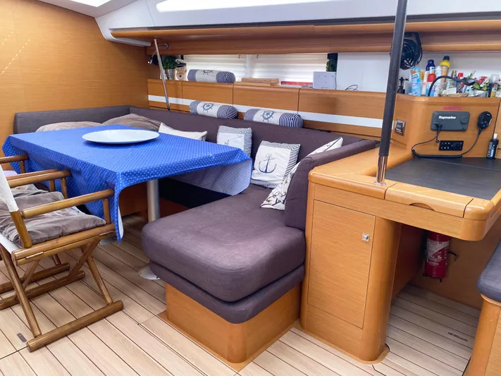  Yacht Photos Pics Interior of 2015 Jeanneau 57 yacht with cozy seating and dining area.