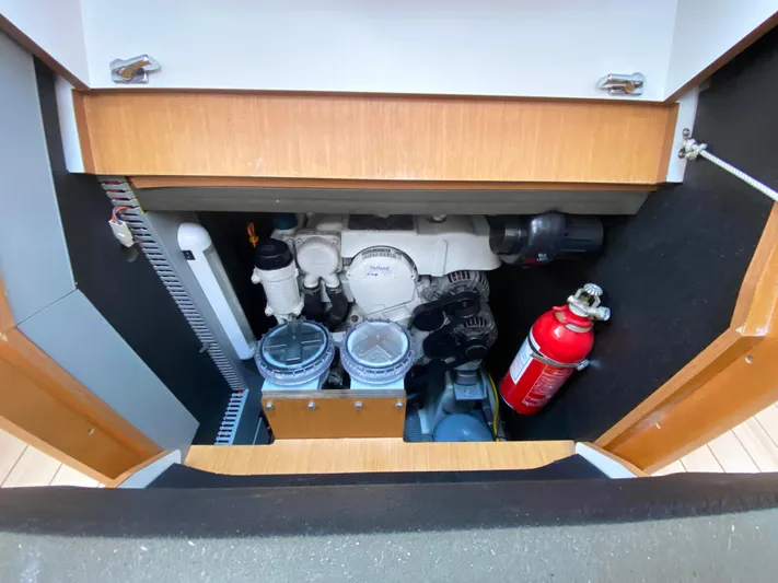  Yacht Photos Pics Engine compartment of 2015 Jeanneau 57 yacht with visible fire extinguisher and mechanical components.
