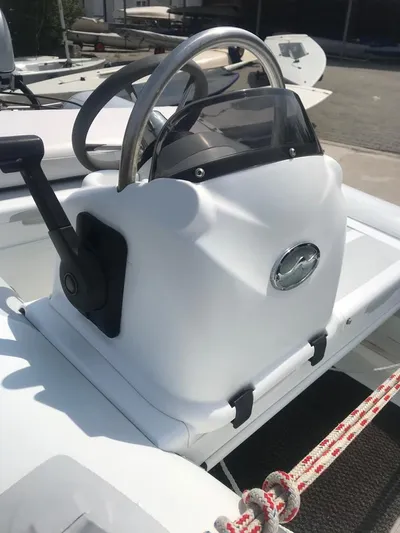  Yacht Photos Pics Steering console of a 2015 Jeanneau 57 yacht, featuring a sleek design and modern controls.