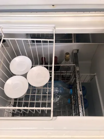  Yacht Photos Pics Refrigerator interior on Jeanneau 57 yacht, 2015 model, with drinks and plates.
