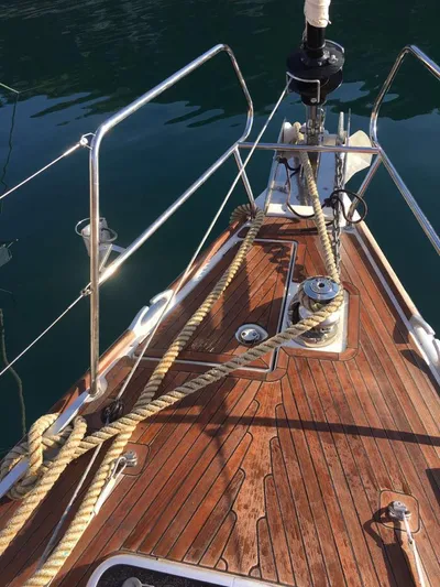  Yacht Photos Pics Bow of 2015 Jeanneau 57 yacht with wooden deck and ropes.