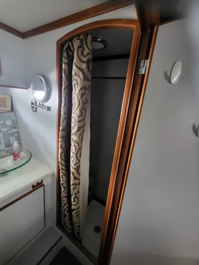 Dunn It Again Yacht Photos Pics 1997 McKinna 48' Pilot House bathroom with shower and patterned curtain.