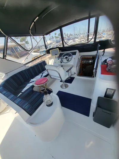 Dunn It Again Yacht Photos Pics 1997 McKinna 48' Pilot House interior with helm, seating, and marina view.