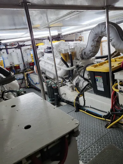 Dunn It Again Yacht Photos Pics Engine room of a 1997 McKinna 48' Pilot House yacht, showcasing machinery and wiring.