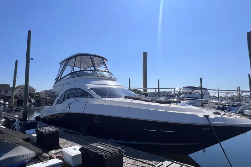  Yacht Photos Pics 2008 Sea Ray 47 Sedan Bridge yacht docked at marina under clear blue sky.