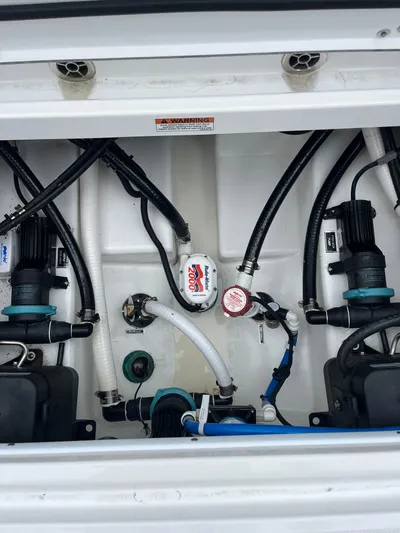  Yacht Photos Pics 2023 Blackfin 272 DC boat engine compartment with hoses and pumps.