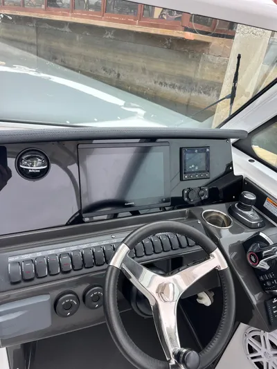  Yacht Photos Pics 2023 Blackfin 272 DC boat dashboard with steering wheel and navigation controls.