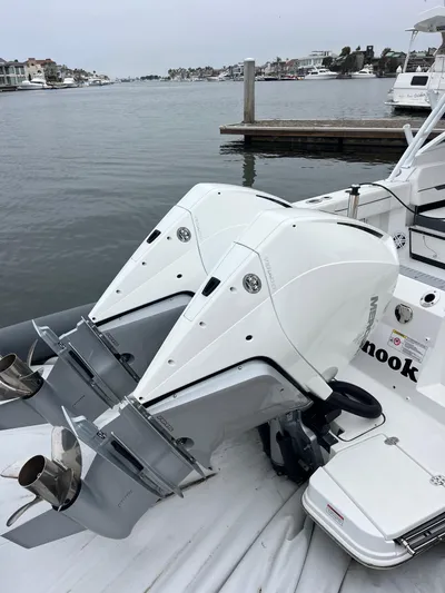  Yacht Photos Pics 2023 Blackfin 272 DC boat with dual outboard motors docked by the waterfront.