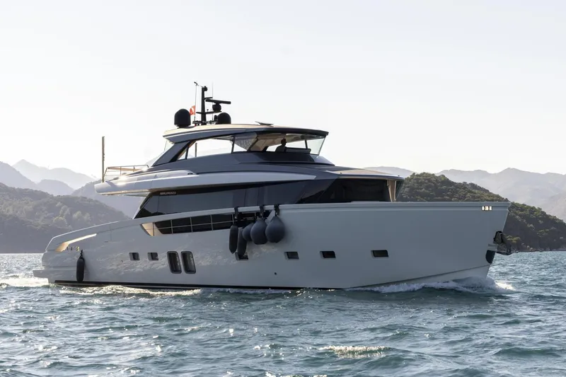  Yacht Photos Pics 2023 Sanlorenzo SX76 yacht cruising on scenic waters with mountainous backdrop.