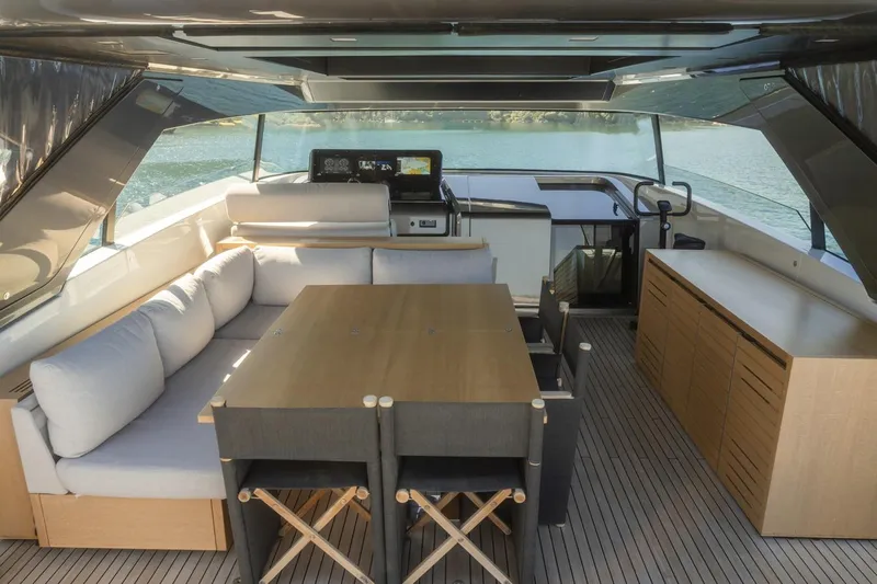  Yacht Photos Pics Luxurious interior of 2023 Sanlorenzo SX76 yacht with elegant seating and dining area.