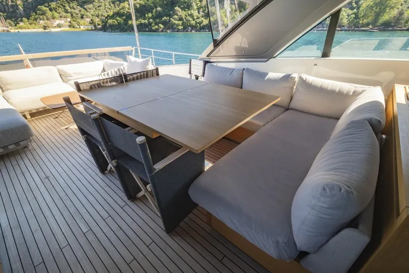  Yacht Photos Pics Luxurious 2023 Sanlorenzo SX76 yacht deck with elegant seating and scenic ocean view.