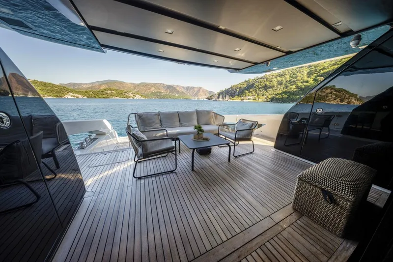  Yacht Photos Pics Luxurious 2023 Sanlorenzo SX76 yacht deck with elegant seating and scenic ocean view.