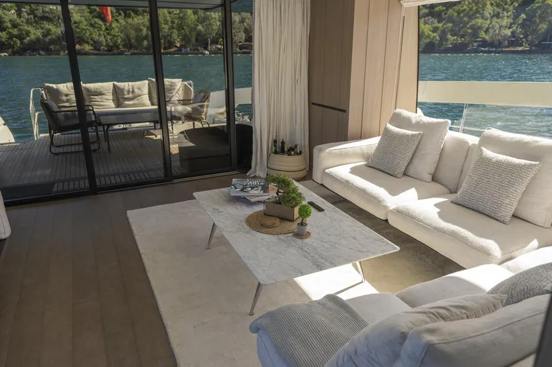  Yacht Photos Pics Luxurious interior of 2023 Sanlorenzo SX76 yacht with elegant seating and scenic water view.