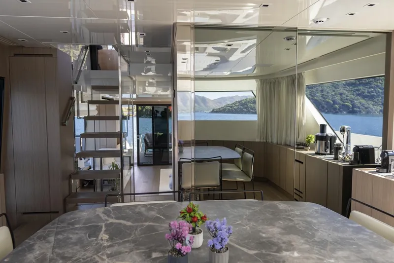 Yacht Photos Pics Luxurious interior of 2023 Sanlorenzo SX76 yacht with modern dining area and scenic views.