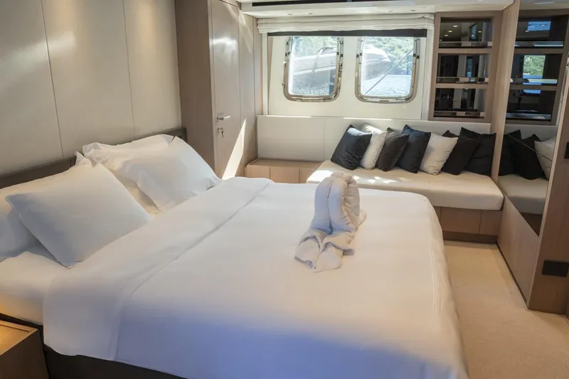  Yacht Photos Pics Luxurious bedroom interior of 2023 Sanlorenzo SX76 yacht with elegant bedding and window seating.