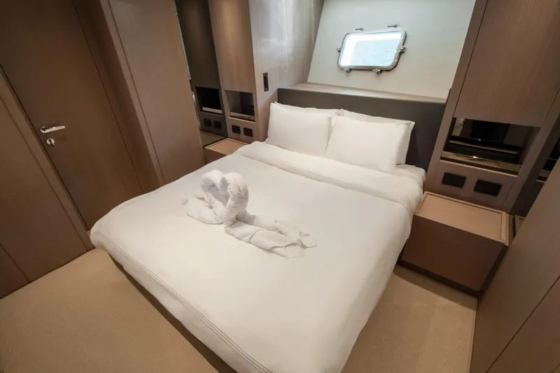  Yacht Photos Pics Luxurious bedroom interior of 2023 Sanlorenzo SX76 yacht with elegant bedding and decor.