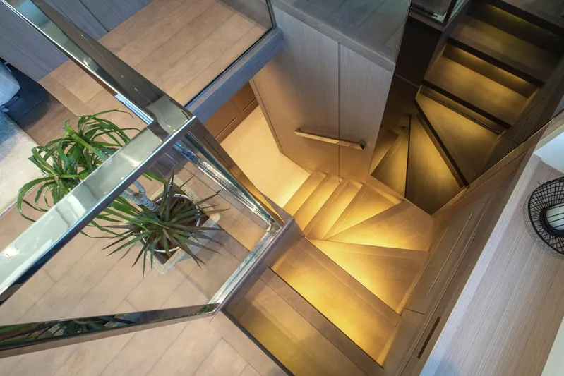  Yacht Photos Pics Luxurious interior staircase of 2023 Sanlorenzo SX76 yacht, featuring modern design and elegant lighting.