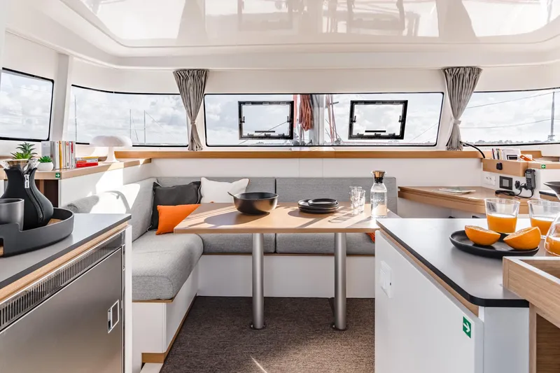  Yacht Photos Pics Luxurious interior of 2026 Excess 11 yacht with modern dining area and panoramic windows.