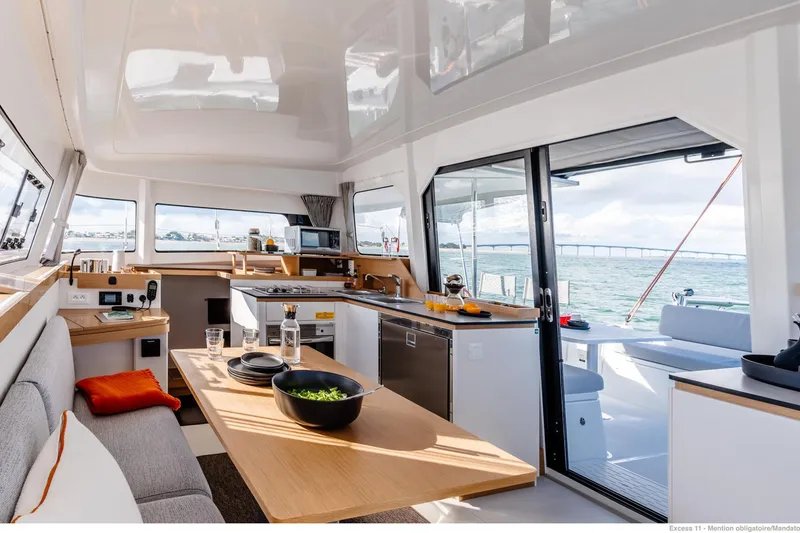  Yacht Photos Pics Luxurious interior of 2026 Excess 11 yacht with modern kitchen and dining area.