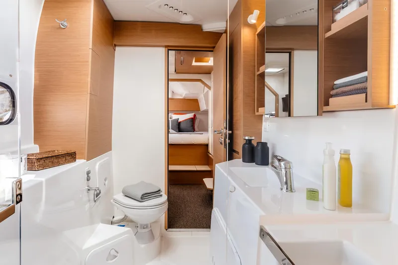  Yacht Photos Pics Luxurious bathroom interior of 2026 Excess 11 yacht, featuring modern fixtures and wooden accents.
