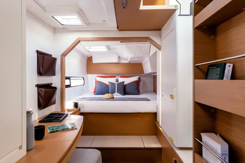  Yacht Photos Pics Luxurious interior of 2026 Excess 11 yacht, featuring cozy bed and modern wooden design.