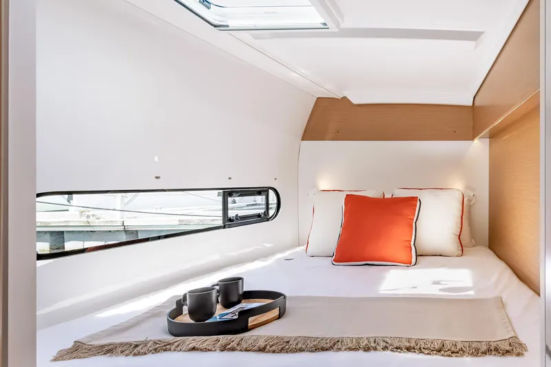  Yacht Photos Pics Luxurious cabin interior of 2026 Excess 11 yacht with cozy bed and stylish decor.