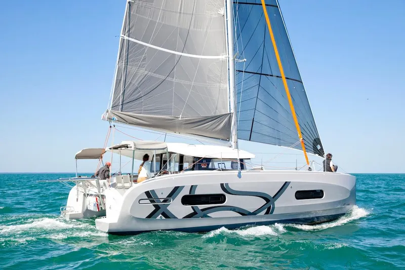  Yacht Photos Pics Sailing catamaran Excess 11, 2026 model, cruising on clear blue ocean waters.