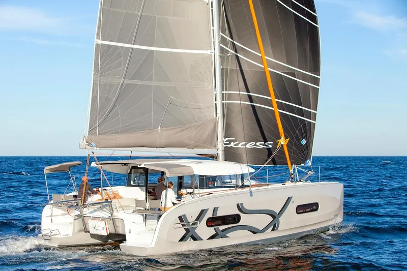  Yacht Photos Pics 2026 Excess 11 catamaran sailing on open sea with modern design and spacious deck.